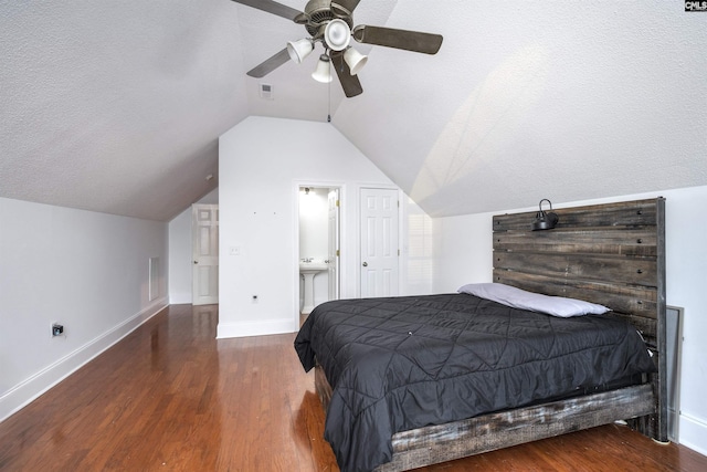 bedroom featuring ceiling fan, dark hardwood / wood-style flooring, ensuite bathroom, and a textured ceiling