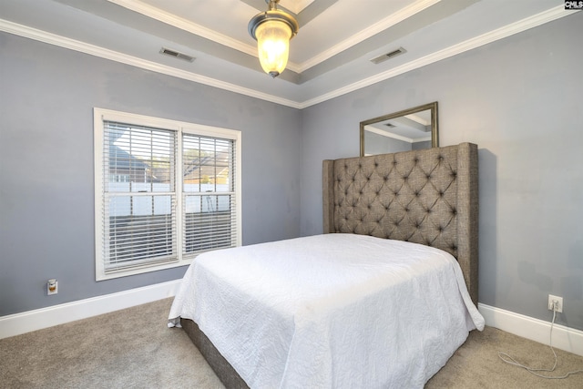 carpeted bedroom with a raised ceiling, ceiling fan, and crown molding