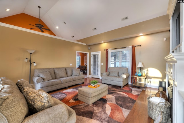 living room with hardwood / wood-style flooring, ceiling fan, ornamental molding, and high vaulted ceiling