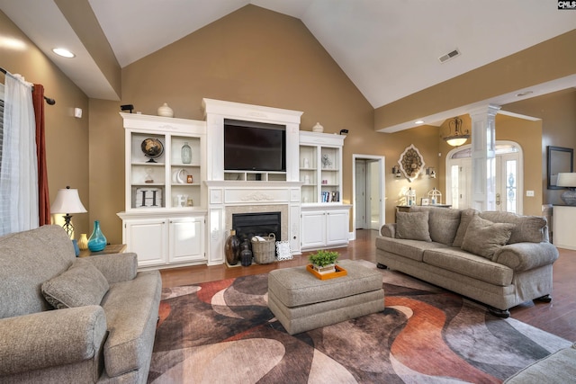 living room featuring dark hardwood / wood-style flooring and high vaulted ceiling