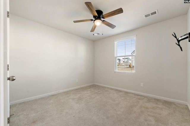 carpeted empty room featuring ceiling fan