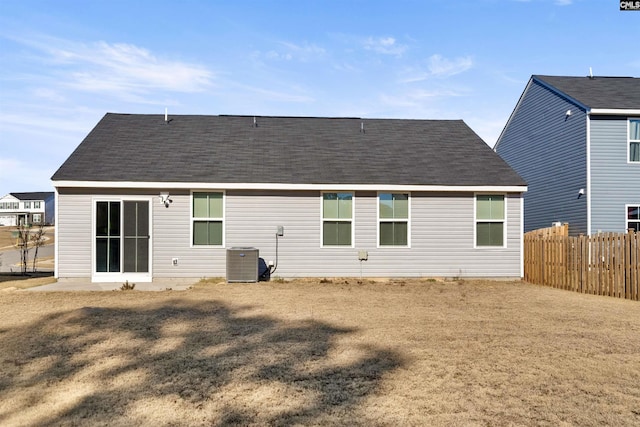 rear view of property with a yard and cooling unit