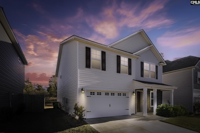 view of front of property featuring a garage, driveway, and board and batten siding