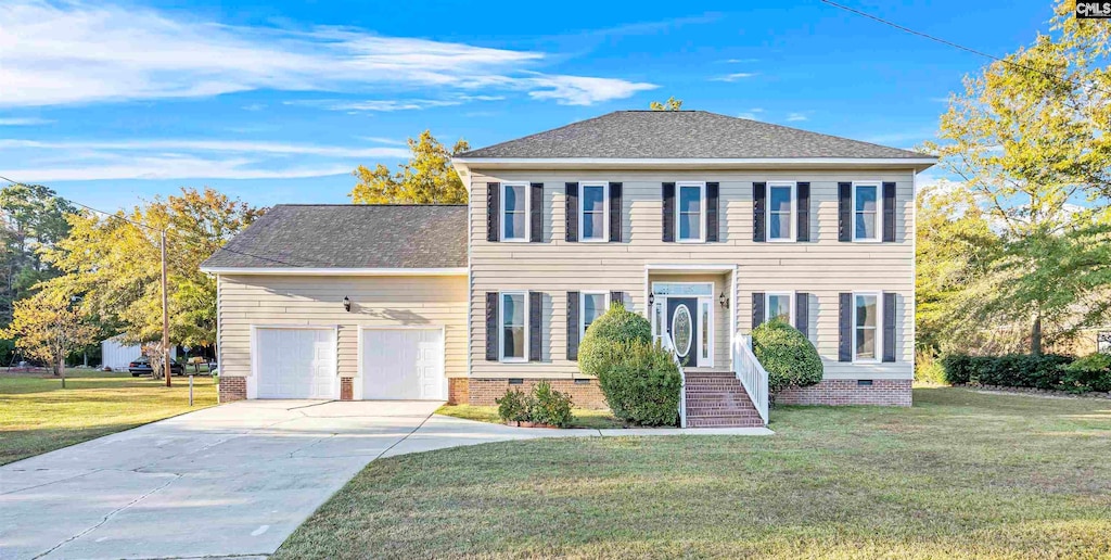 colonial inspired home with a front yard and a garage