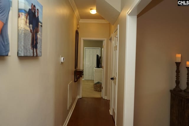 hallway with a textured ceiling, crown molding, and dark hardwood / wood-style floors