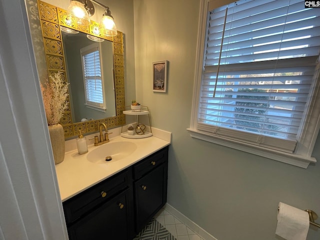 bathroom with tile patterned flooring, a healthy amount of sunlight, and vanity