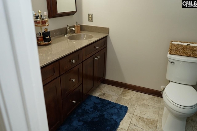 bathroom featuring toilet and vanity