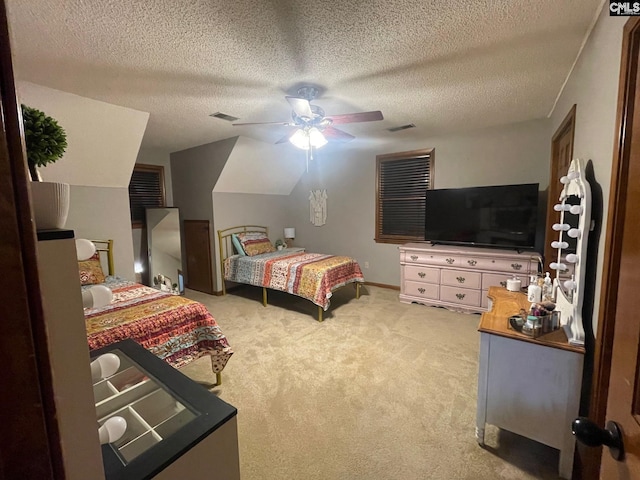 bedroom with a textured ceiling, ceiling fan, and carpet