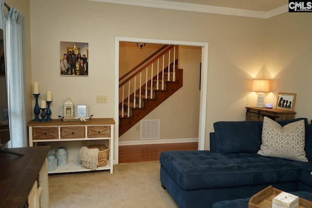 living room with ornamental molding and carpet