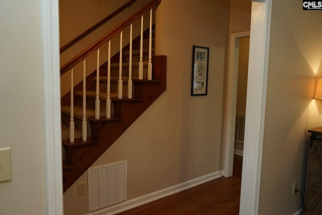 staircase featuring wood-type flooring