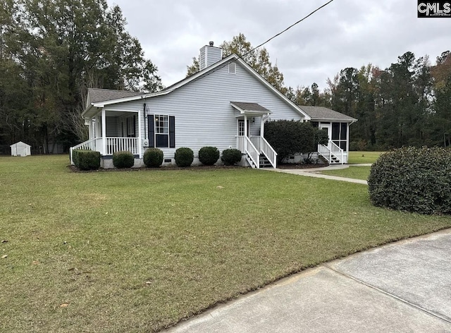 single story home featuring a sunroom and a front lawn