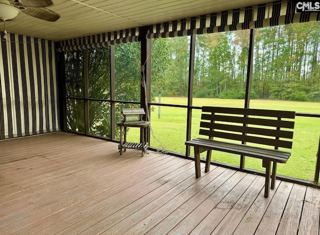 unfurnished sunroom featuring ceiling fan