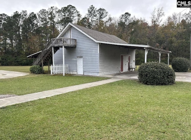 view of home's exterior with a lawn and a carport