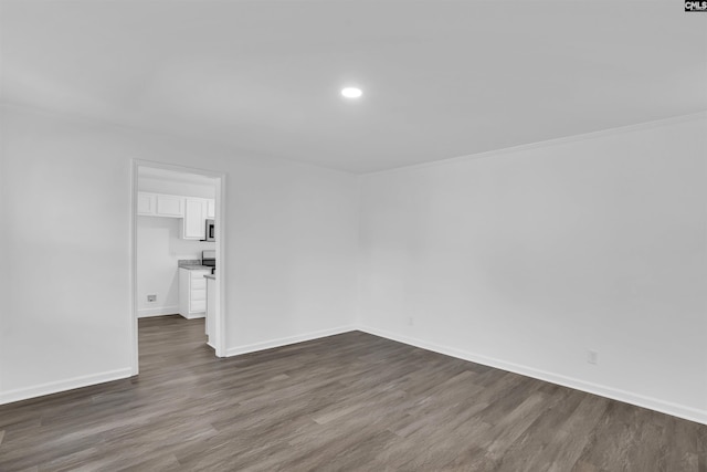 unfurnished room featuring dark wood-type flooring