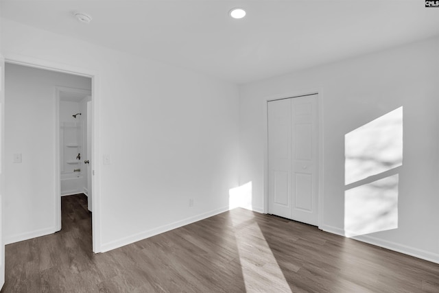 spare room with dark wood-type flooring