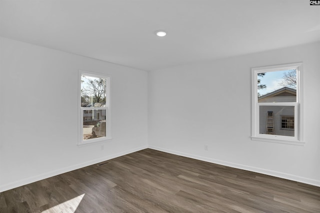 unfurnished room featuring dark hardwood / wood-style floors