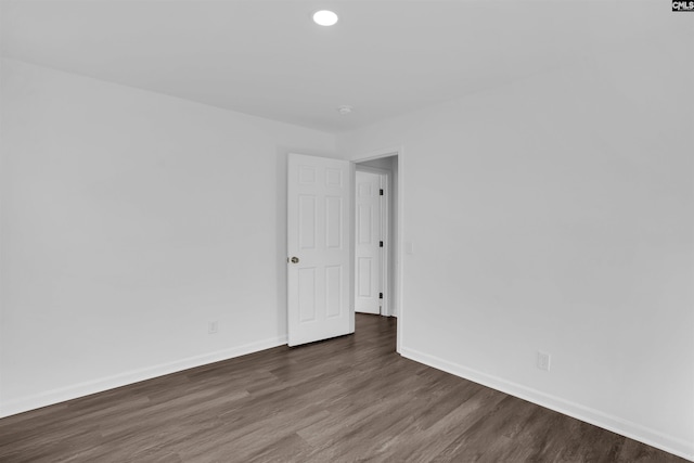 empty room featuring dark hardwood / wood-style flooring