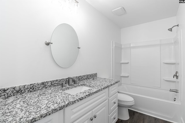 full bathroom featuring toilet, washtub / shower combination, wood-type flooring, and vanity