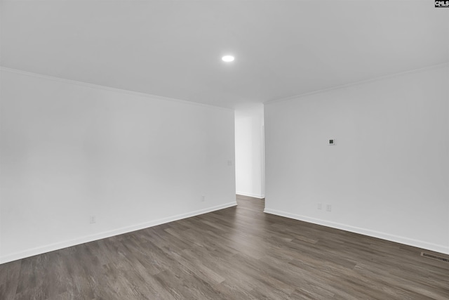 unfurnished room with ornamental molding and dark hardwood / wood-style flooring