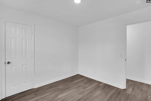 empty room with dark wood-type flooring