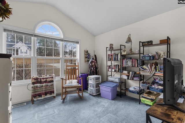 sitting room with vaulted ceiling and carpet flooring