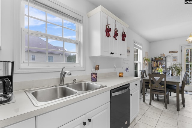 kitchen featuring sink, black dishwasher, white cabinetry, and light tile patterned floors