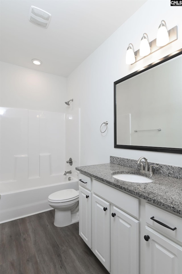 full bathroom with toilet, vanity, hardwood / wood-style flooring, and shower / bath combination