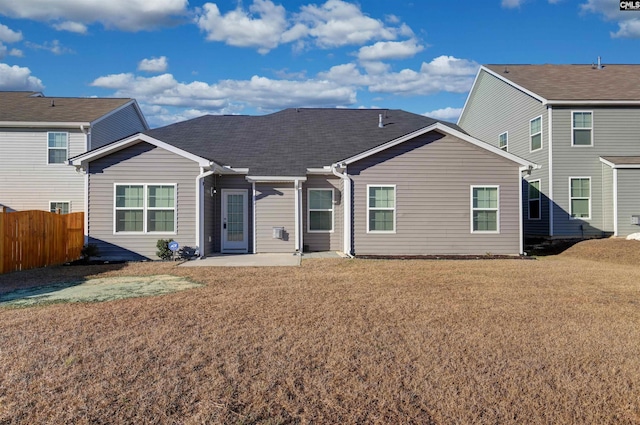 back of property featuring a patio and a lawn