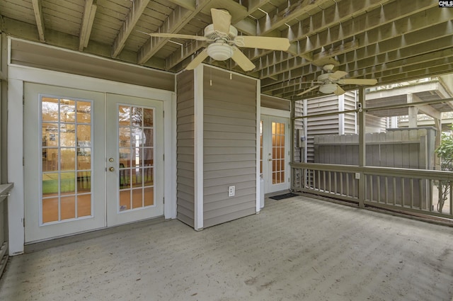 unfurnished sunroom with ceiling fan and french doors