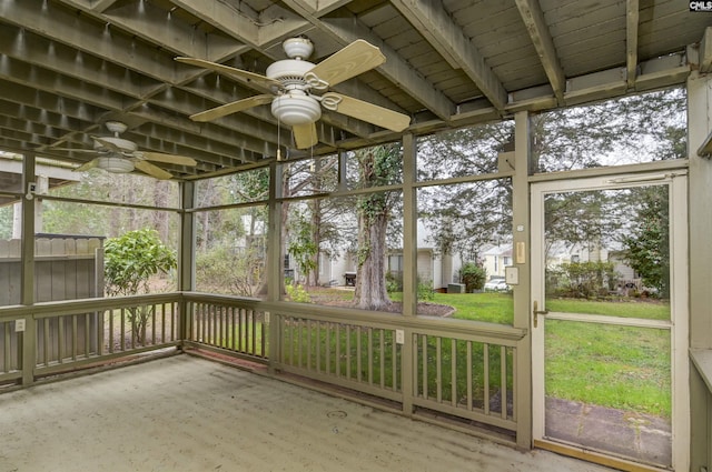 unfurnished sunroom with ceiling fan