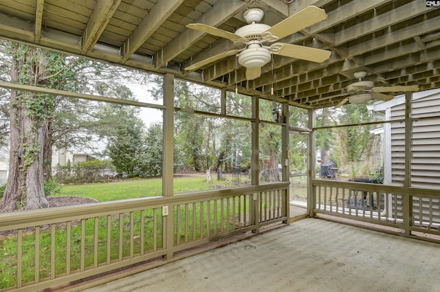 unfurnished sunroom with ceiling fan