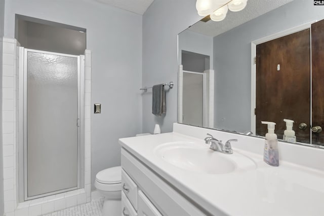 bathroom with a textured ceiling, tile patterned flooring, a shower with shower door, toilet, and vanity