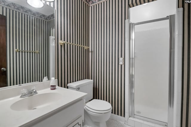 bathroom featuring toilet, an enclosed shower, and vanity