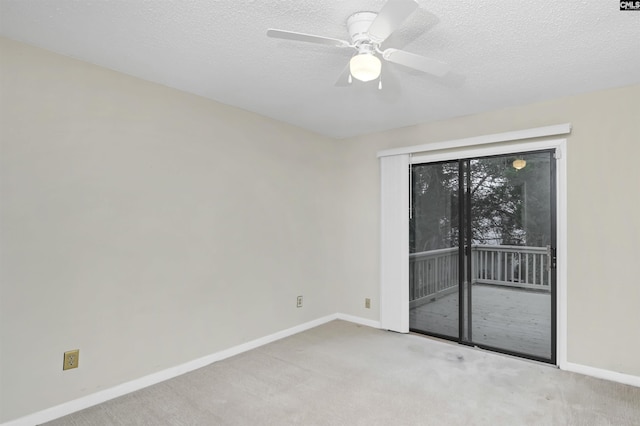 empty room featuring light colored carpet, ceiling fan, and a textured ceiling