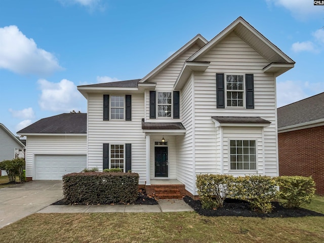 view of front of house featuring a front lawn and a garage