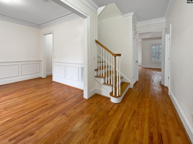 interior space with hardwood / wood-style floors and crown molding