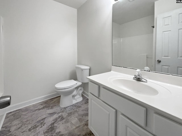 bathroom featuring walk in shower, vanity, and toilet