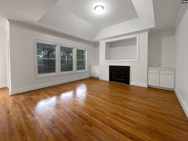 unfurnished living room featuring crown molding and hardwood / wood-style floors