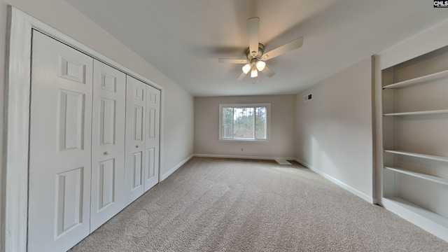 unfurnished bedroom featuring ceiling fan and light colored carpet