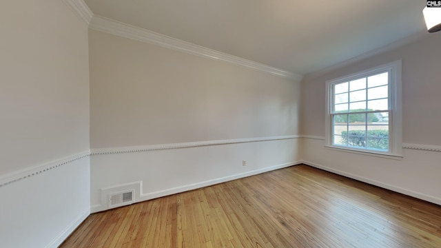 unfurnished room with ornamental molding and wood-type flooring