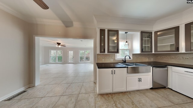 kitchen with sink, white cabinetry, ceiling fan, decorative backsplash, and hanging light fixtures