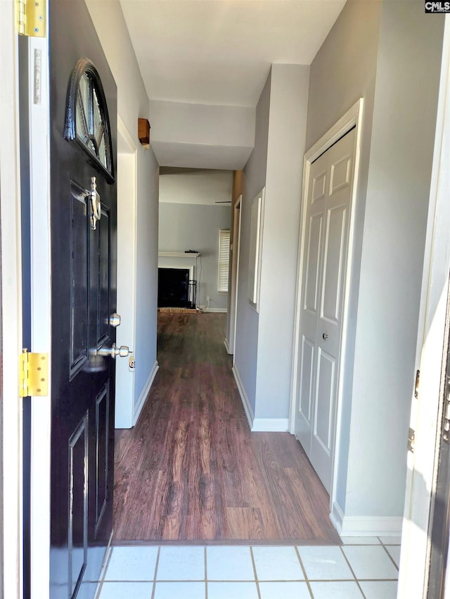 corridor with hardwood / wood-style flooring