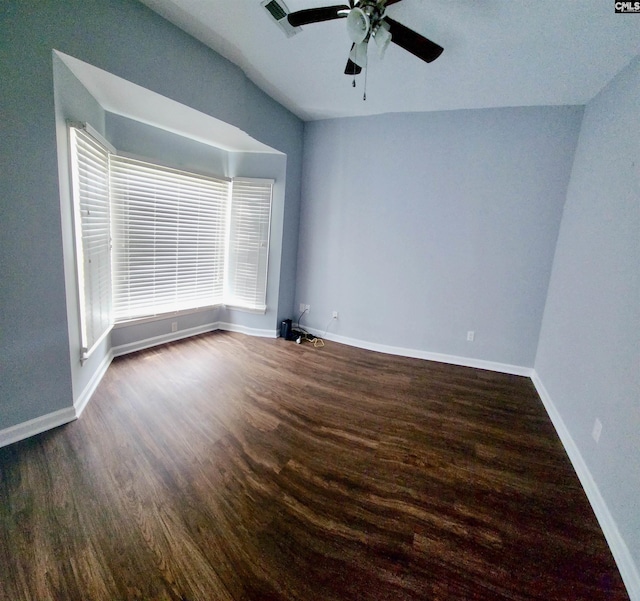 unfurnished room with ceiling fan and dark hardwood / wood-style flooring