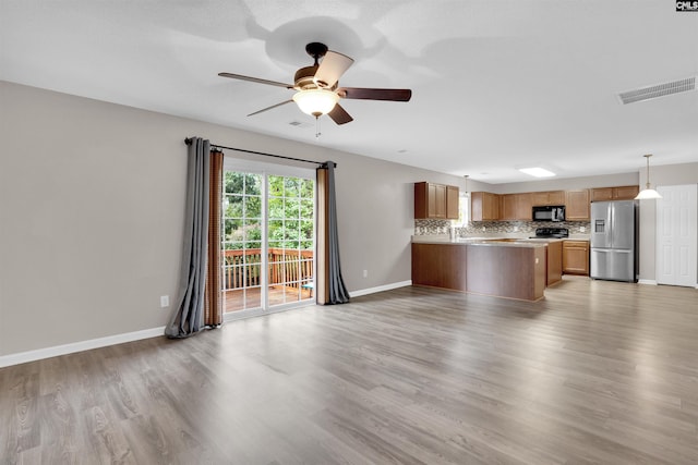 unfurnished living room with ceiling fan and light hardwood / wood-style flooring