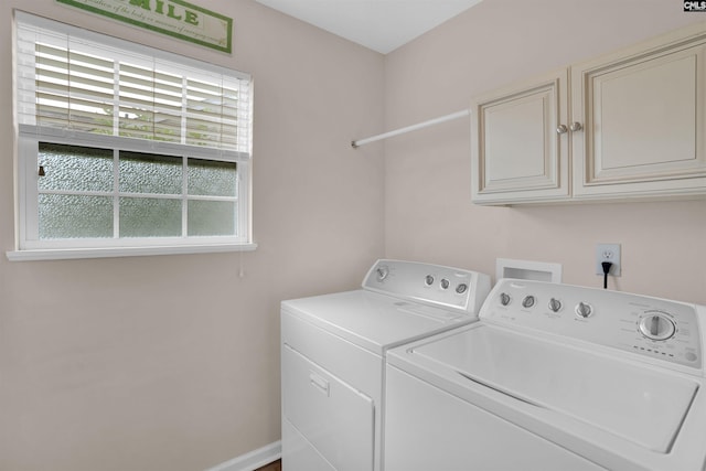 laundry room with washer and dryer and cabinets