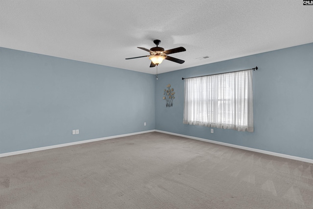 carpeted empty room featuring a textured ceiling and ceiling fan