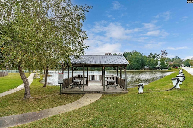 dock area featuring a gazebo, a yard, and a water view