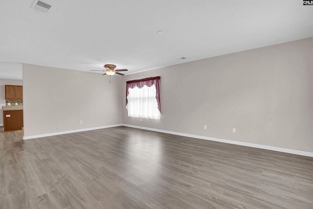 empty room featuring ceiling fan and light hardwood / wood-style flooring