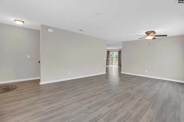 spare room featuring light hardwood / wood-style floors and ceiling fan