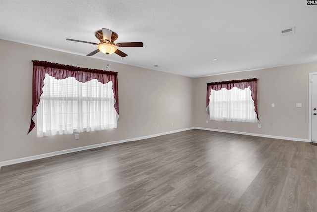 unfurnished room featuring ceiling fan, a textured ceiling, and wood-type flooring